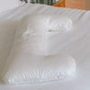The Pillow Bar Slumberlicious Down Body Pillow on dressed bed.