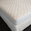 TOM Washable Wool Quilted Mattress Protector corner detail shot fitted onto mattress.
