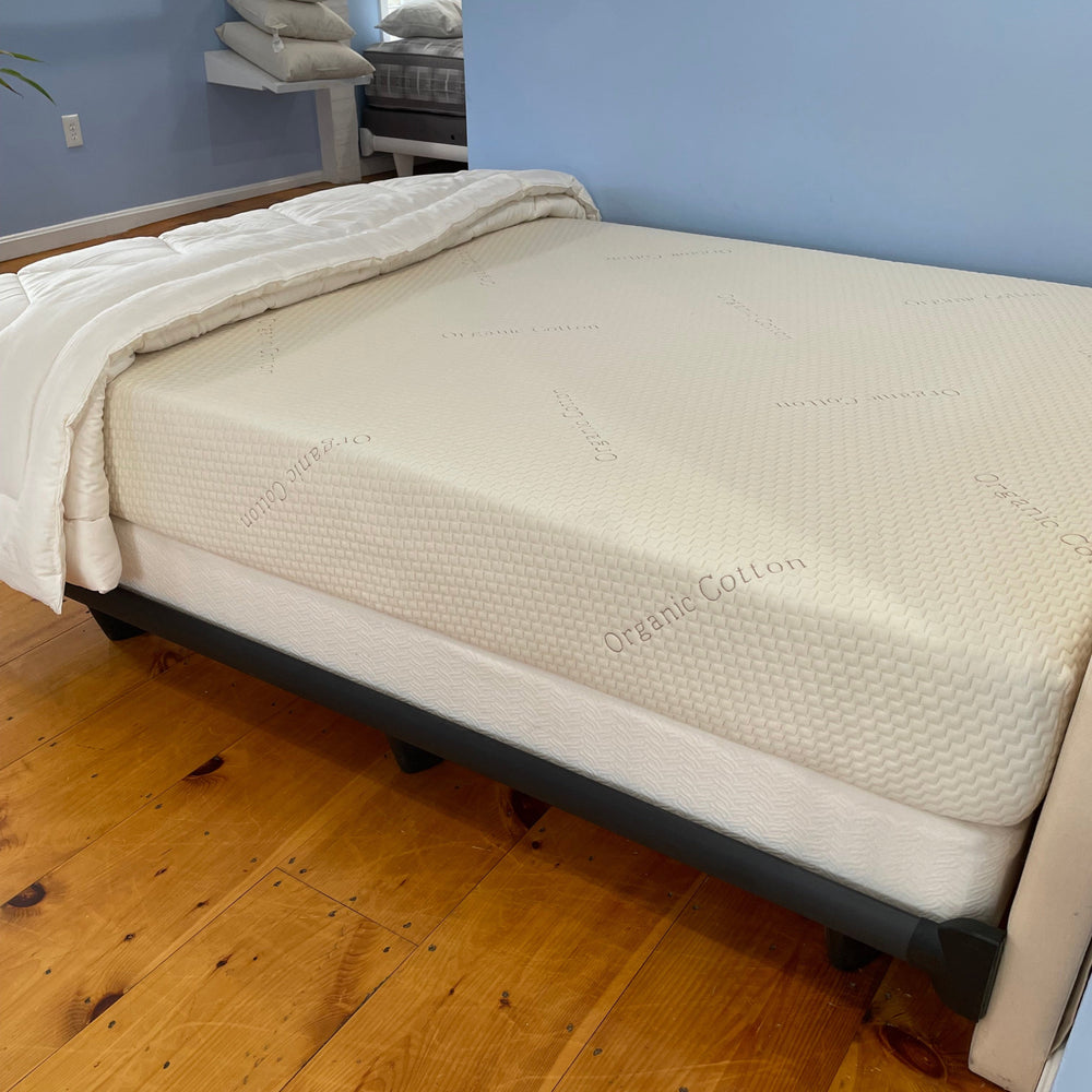 Mattress on a wooden floor with a blue wall in the background