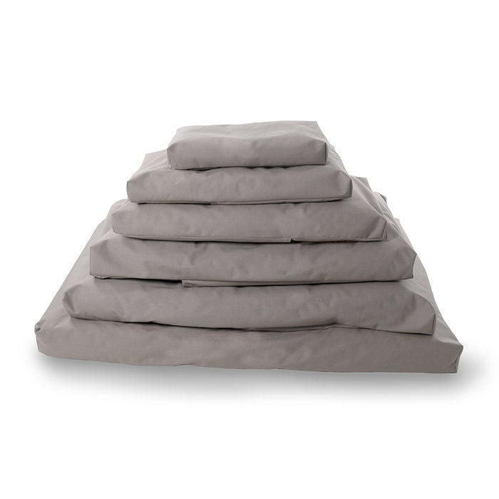 Stacked and folded set of Naturepedic Organic Pet Bed with Washable Waterproof Cover