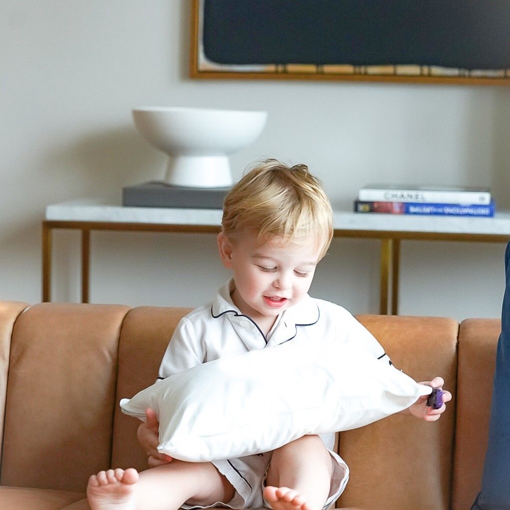 Little boy holding The Pillow Bar Down Boudoir Pillow