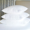 The Pillow Bar Custom Down Sleeping Pillows stacked in sizes standard, queen, and king.