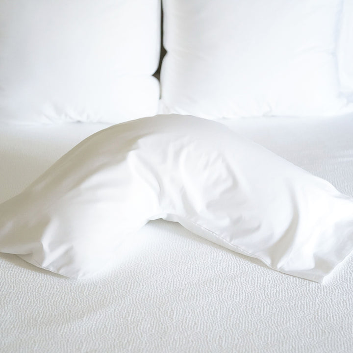The Pillow Bar Cotton Sateen Pillowcases placed on mattress