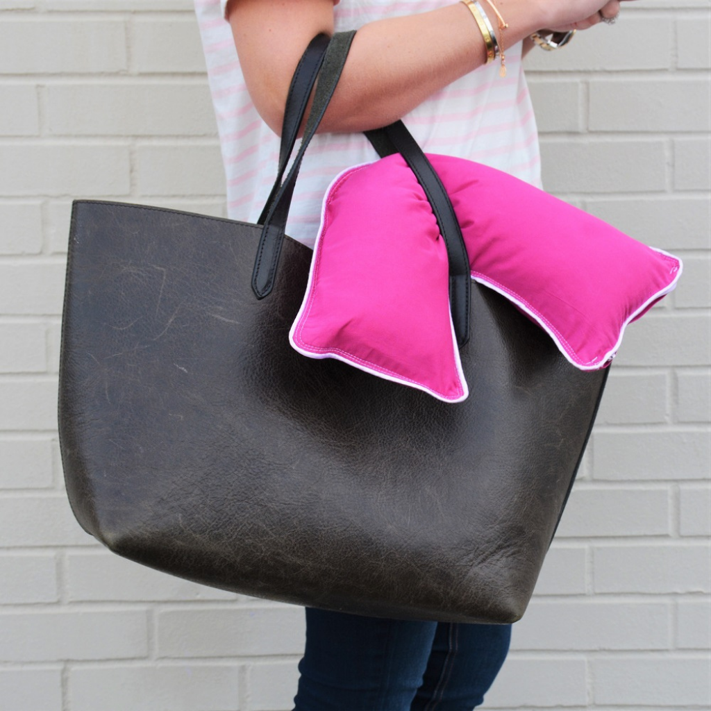 woman holding The Pillow Bar Jetsetter Mini Down Pillow 